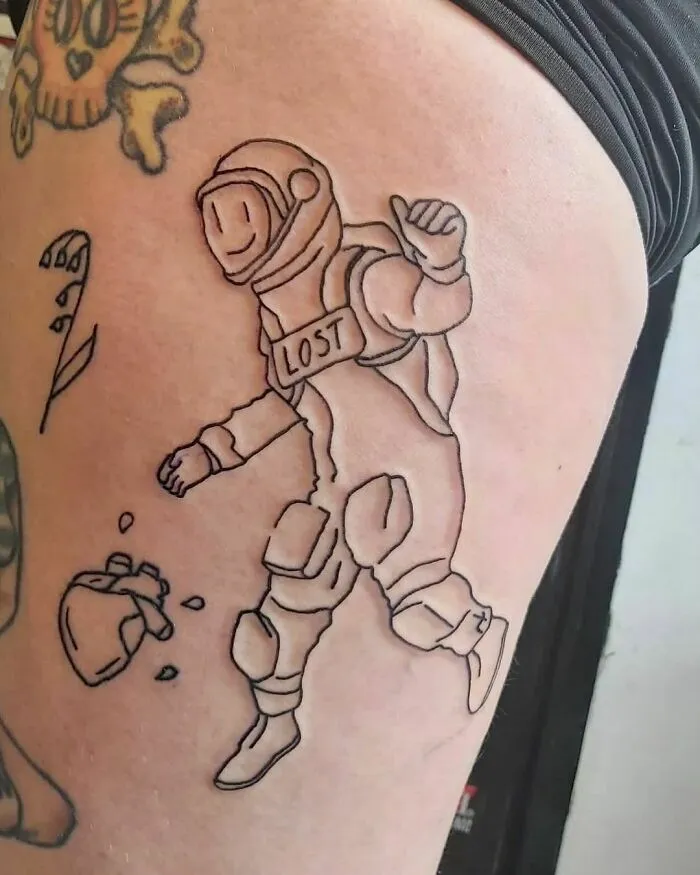 Line art tattoo of an astronaut with "Lost" on helmet, symbolic of space and astrology themes.