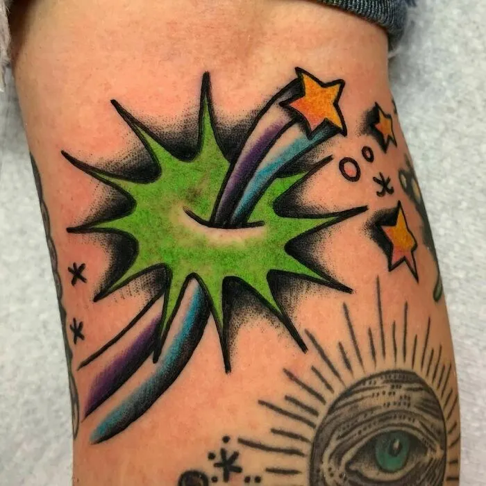Colorful space tattoo featuring stars and an abstract design with cosmic elements.