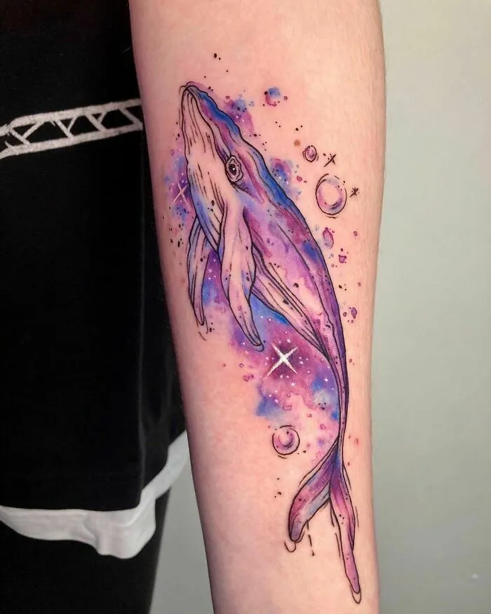 Whale space tattoo with cosmic background and stars, ideal for astrology fans.
