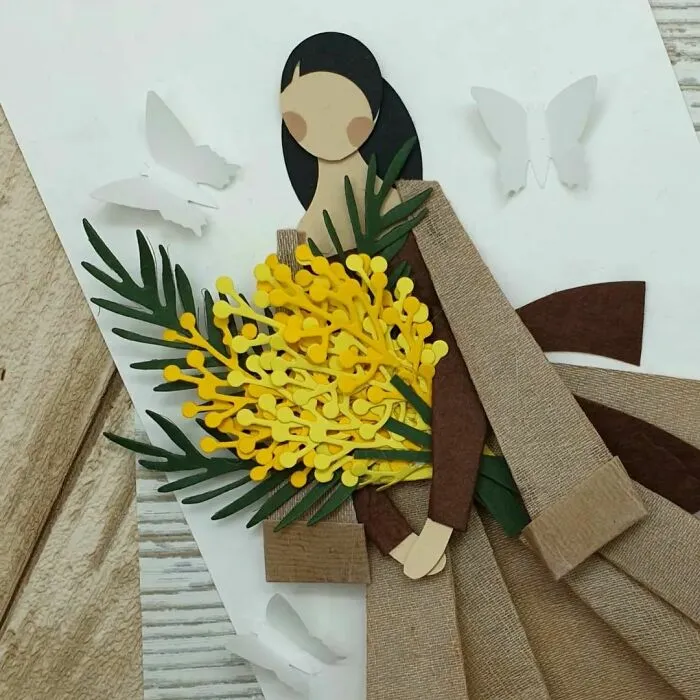 card made out of the paper on which woman with bouquet