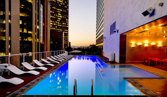 Swimming pool at the roof with beach chairs