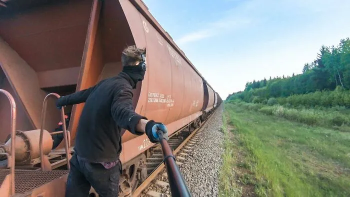 Man train surfing while filming 