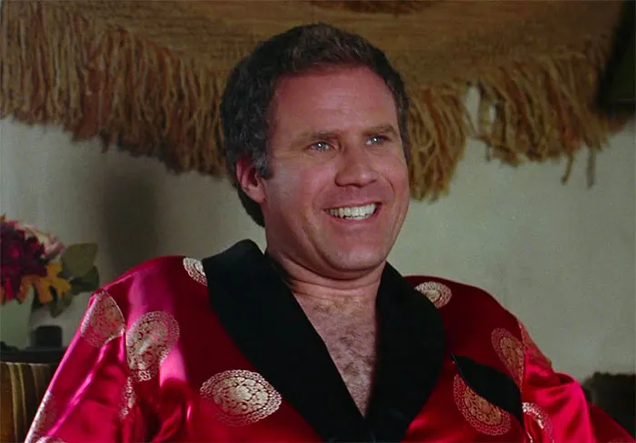 Will Ferrell sitting and smiling in movie Wedding Crashers
