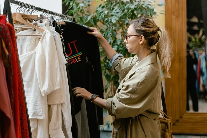Woman Looking Through Different Clothes 
