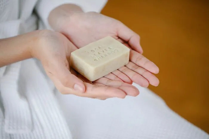 Person Holding Dry Shampoo in Hands 