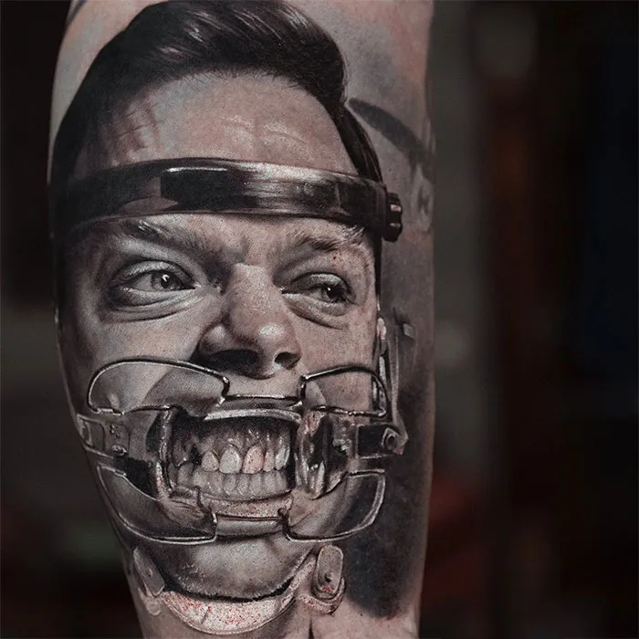 Super realistic tattoo of Lockhart from "A Cure For Wellness," showcasing intense dental apparatus detail.