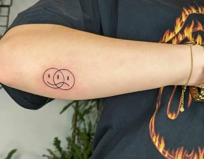 Overlapping Happy and Sad Smile Emojis