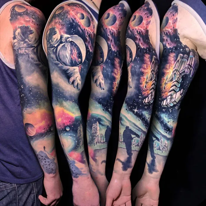 Vibrant arm sleeves with space tattoos featuring astronauts, planets, and galaxies, ideal for astrology enthusiasts.