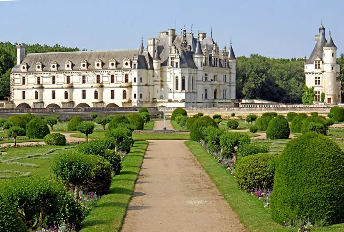 Photo of white castle in green garden