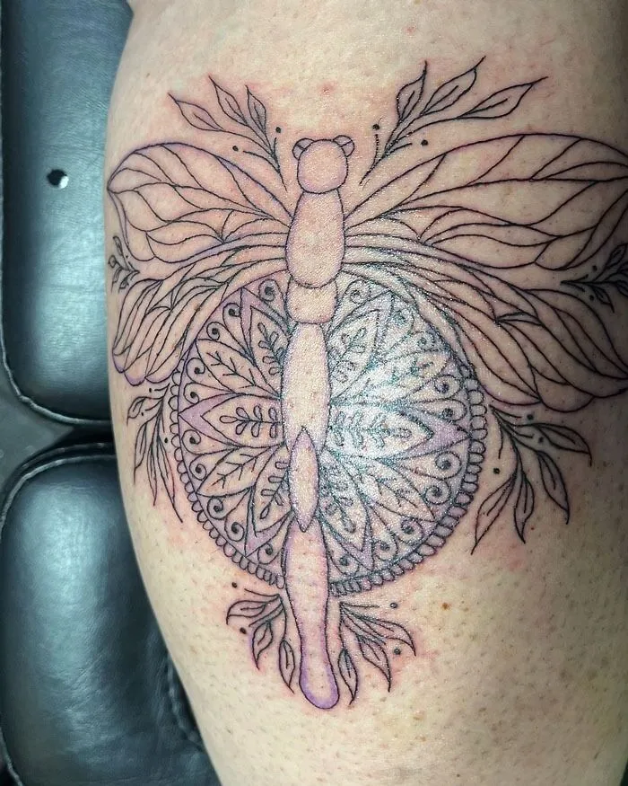 Intricate lower leg tattoo with a mandala and dragonfly design.