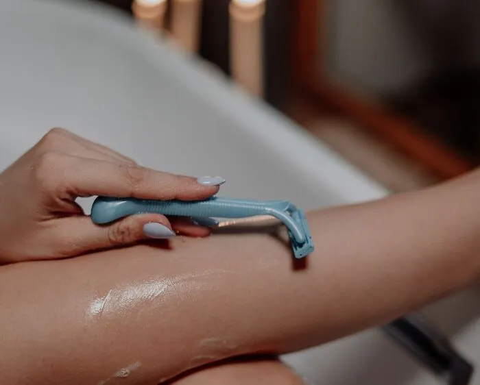 Woman Shaving Leg 