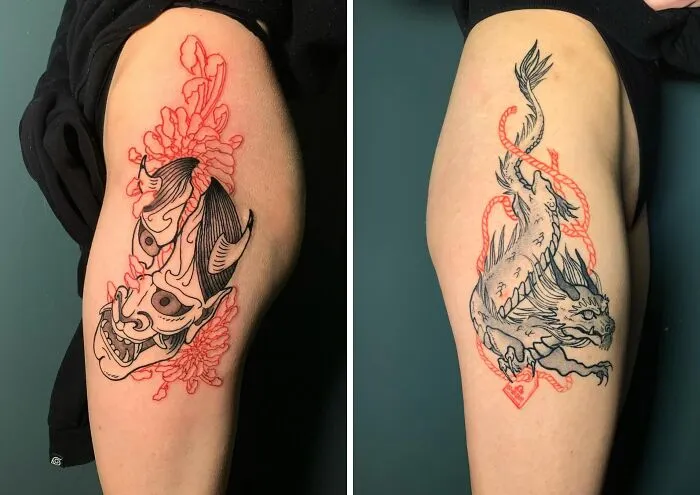 Red ink tattoos featuring a demon mask and dragon design on the arm.