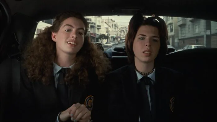 Two people in school uniforms sitting in a car, representing an iconic best friend duo.