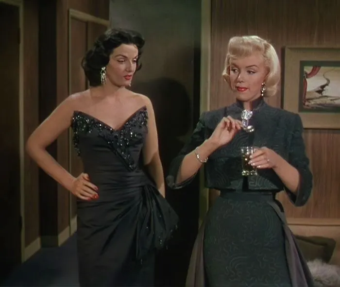 Two women in elegant dresses, classic iconic best friend duo in a stylish setting.