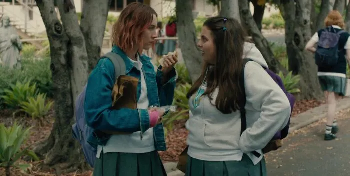 Two best friend duos in uniforms engaging and smiling outdoors, reflecting iconic friendship moments.