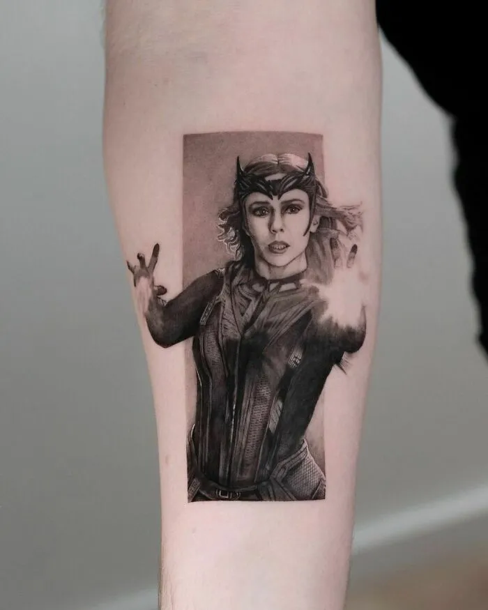 Marvel tattoo featuring a powerful female character Wanda Maximoff casting a spell on the forearm.