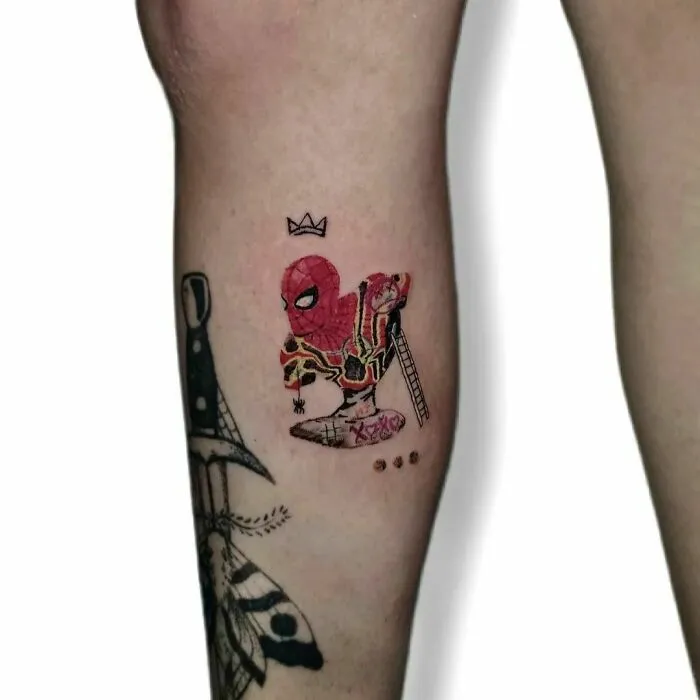 Marvel tattoo featuring Spider-Man in vibrant colors on a leg, showcasing artistic detail and creativity.