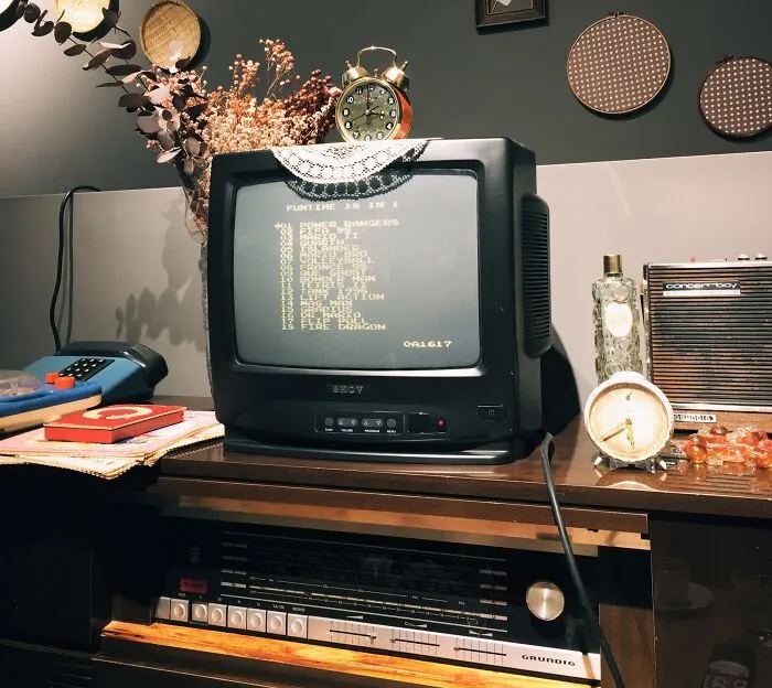 Old Tv On The Table With  Cloth On Top Of It 