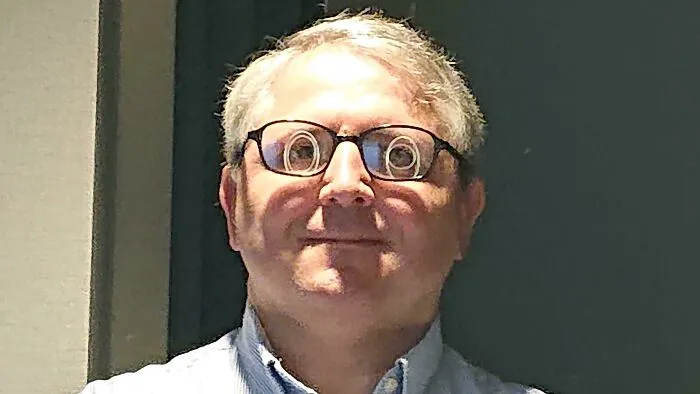 Funny reflections on a man's eyeglasses 