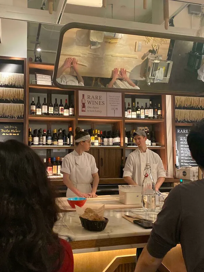 Mirror reflection of people making food 