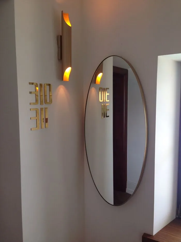 Funny message on the wall seen on a mirror reflection 