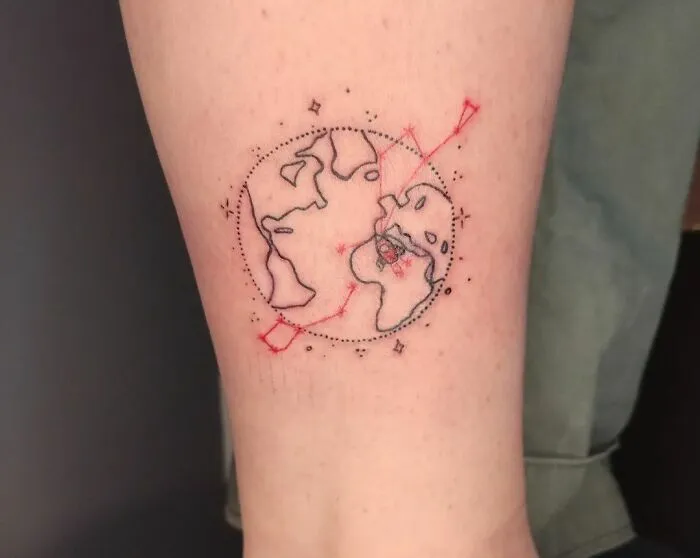 Space tattoo featuring a geometric Earth design with red and black ink lines and dots on a person's forearm.