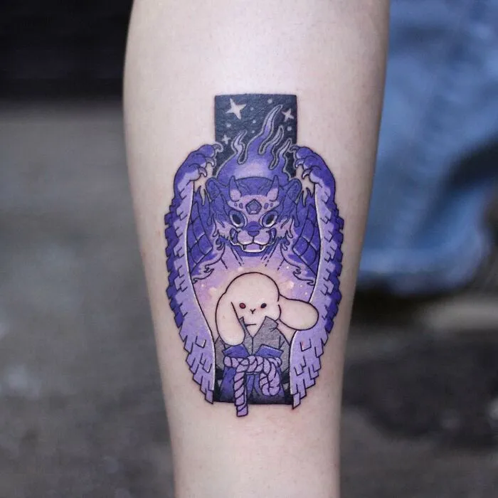 Adorable animal-themed tattoo design featuring a purple mythical creature and a cute bunny on an arm.