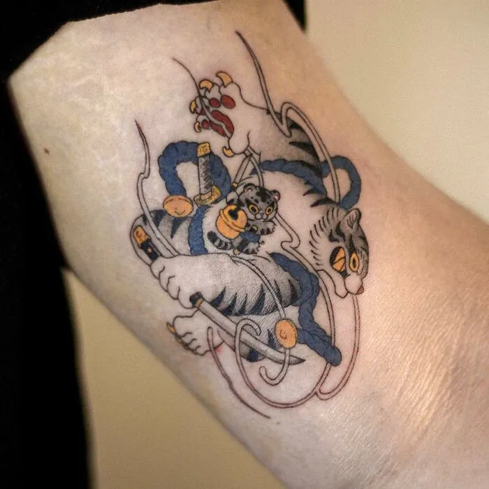 Adorable animal-themed tattoo design featuring playful felines in a creative composition.