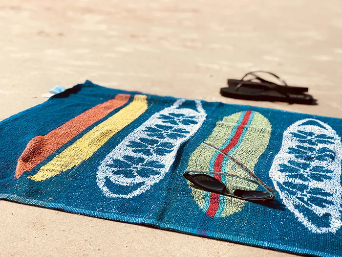 Tower with glasses and flip flops at the beach
