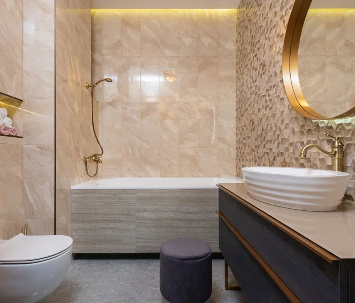 Stylish bathroom with elegant fixtures, textured wall, and modern lighting. Home decoration idea for small spaces.