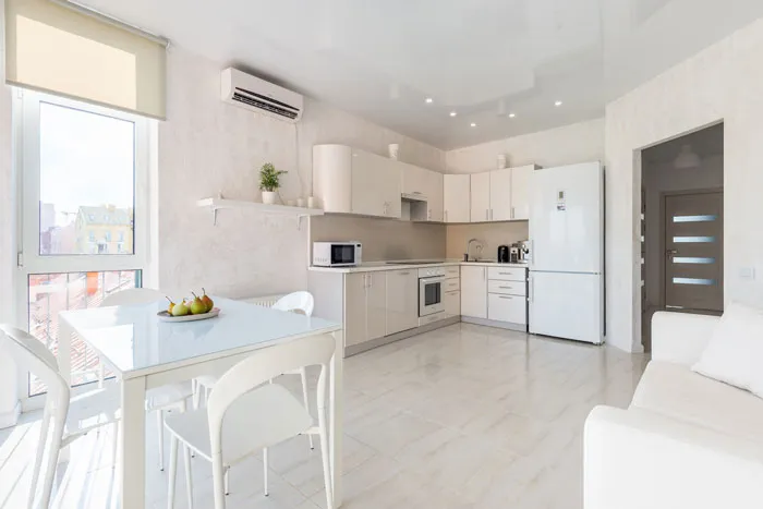 Modern kitchen design with white cabinets and sleek decor, enhancing home decoration.