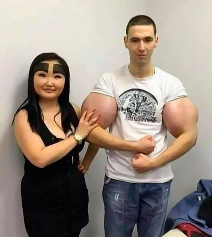 A woman stands beside a man flexing enormous biceps, showcasing important images that are hard to believe are real.