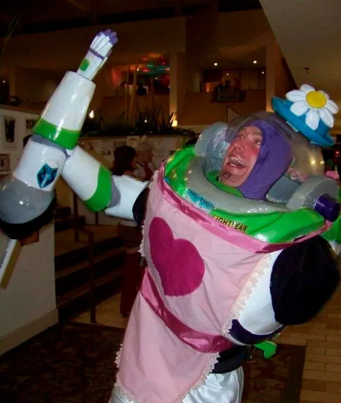 Person in a humorous costume with a heart apron and flower hat, embodying important images of quirky real-life events.