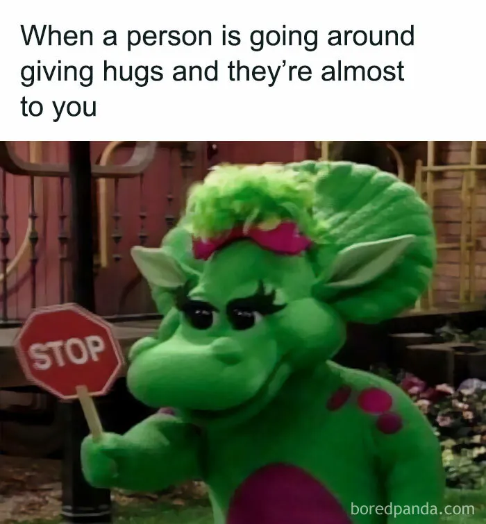Green dinosaur holding a stop sign, humorously warning about unwanted hugs in a spicy meme to spice up your day.