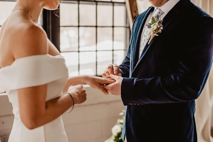 Bride and groom exchanging rings, symbolizing commitment and challenging relationship myths.