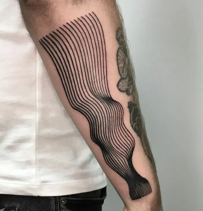Optical illusion tattoo on arm featuring wavy lines creating a distorted, eye-catching design.