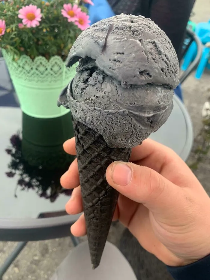 Grey ice cream in brown cone 