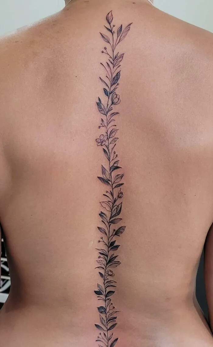 Elegant spine tattoo featuring a floral design down the back.