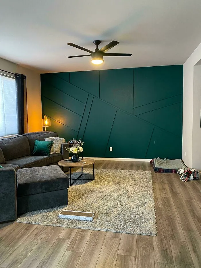 Grey couch next to a wooden coffee table 