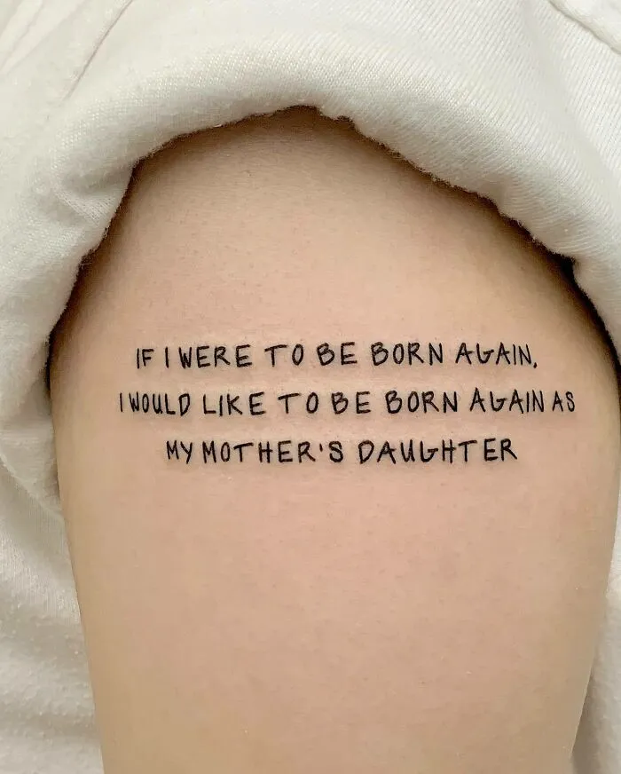 Tattoo on arm with a heartfelt quote symbolizing unbreakable family bonds.