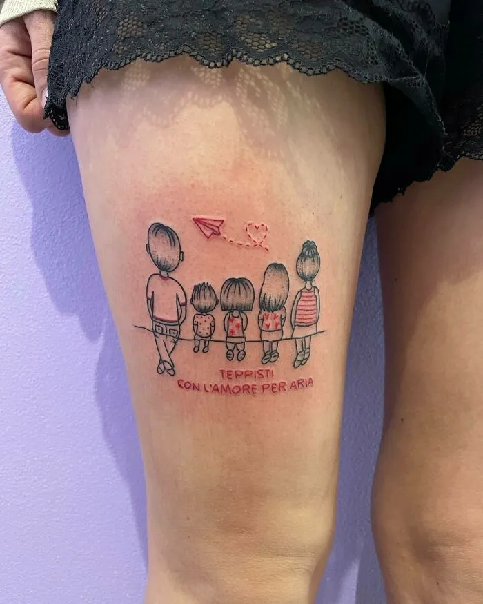 Family tattoo depicting stick figures and a paper airplane on the thigh, symbolizing unbreakable family bonds.