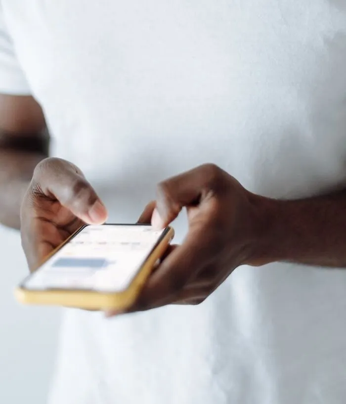 person writing something on his mobile phone