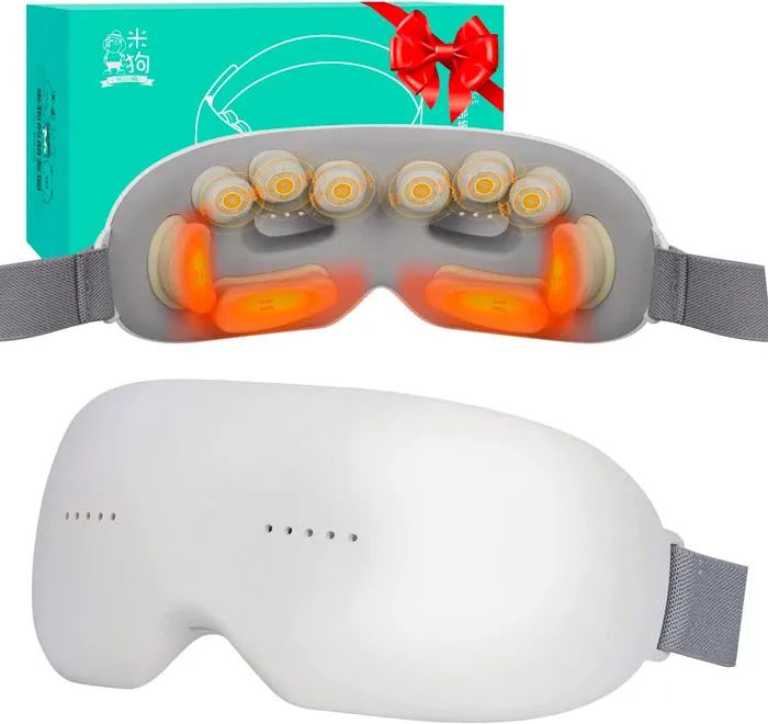 heating eye massager on the background of a present box
