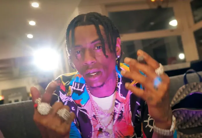 Soulja Boy showing off his jewelry on fingers 