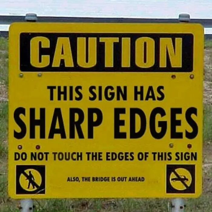 Funny sign warning of sharp edges, with additional caution about a bridge ahead.