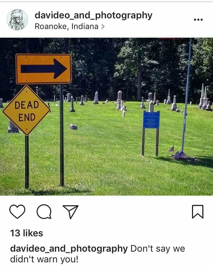 Cemetery with a funny "Dead End" sign pointing toward tombstones, captured for an Instagram page featuring humorous signs.