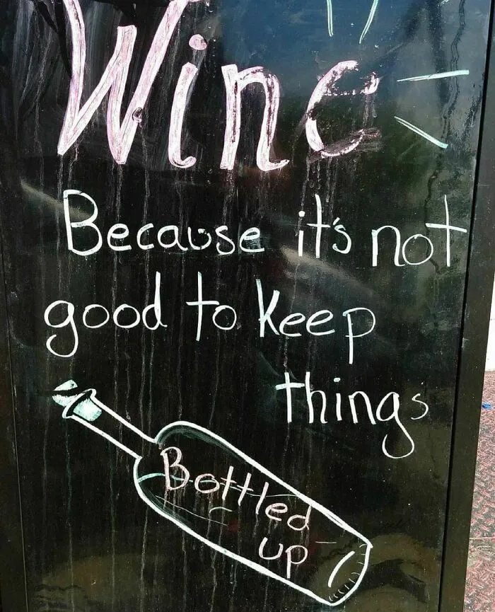 Funny sign with the text: "Wine: Because it's not good to keep things bottled up."