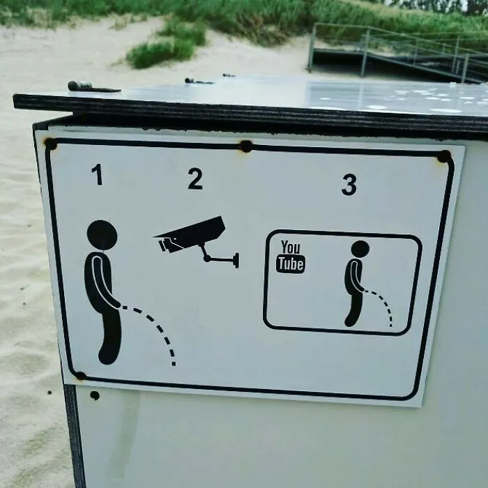 Funny sign with stick figure peeing under surveillance, ending with a YouTube video illustration.