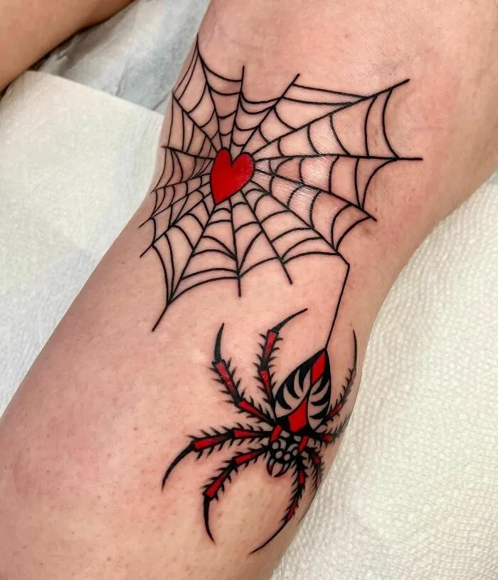 American traditional tattoo with a spider and web, featuring a red heart on the web.