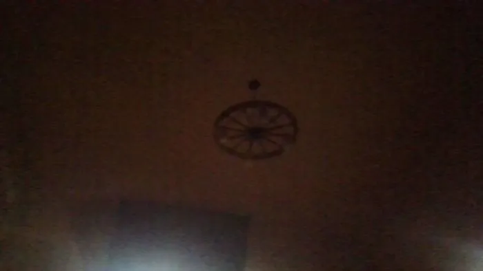 Its A Little Hard To Make Out Because The Laptop Cam But Its A Wagonwheel With Lights On It And Mason Jars Over The Lightbulbs